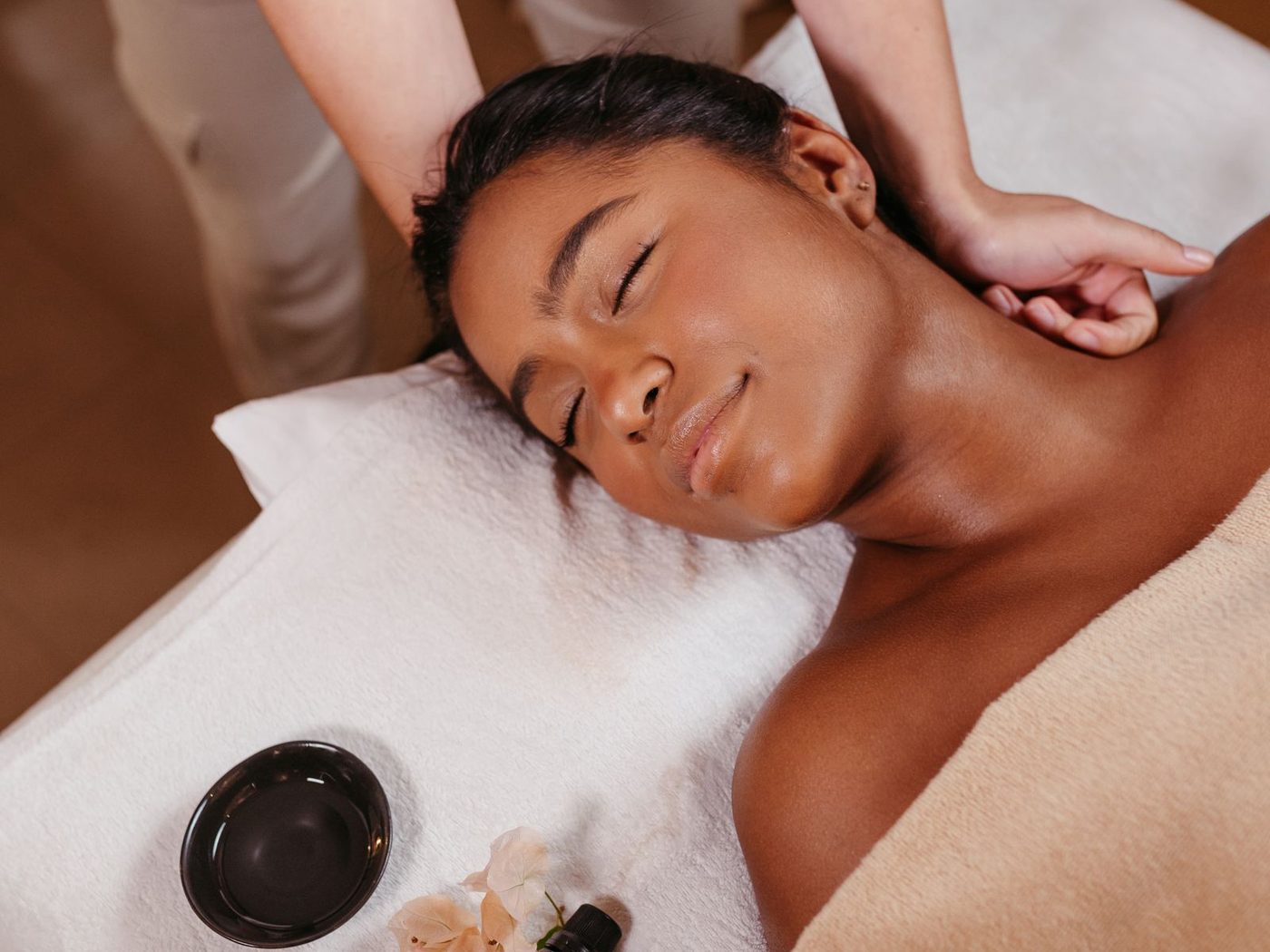 A client resting calmly on a massage table
