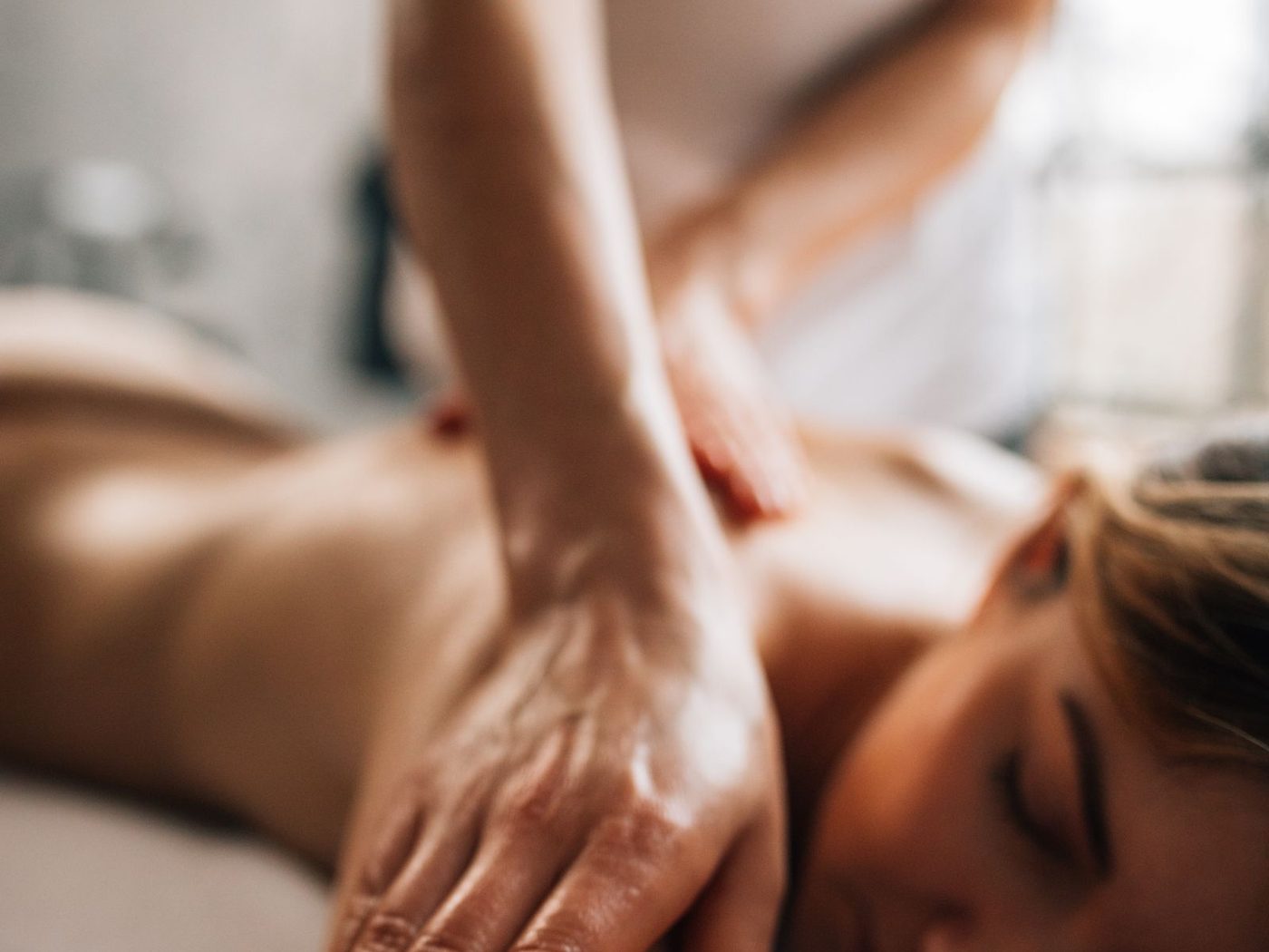 A therapist working on a client's arm and shoulder